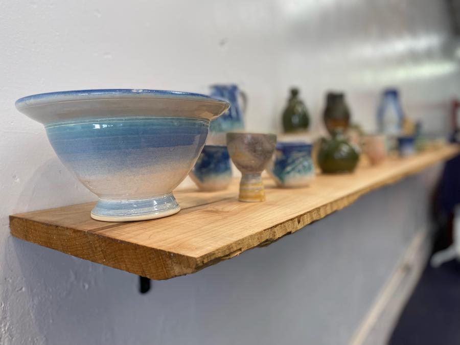 glazed pottery items on a shelf