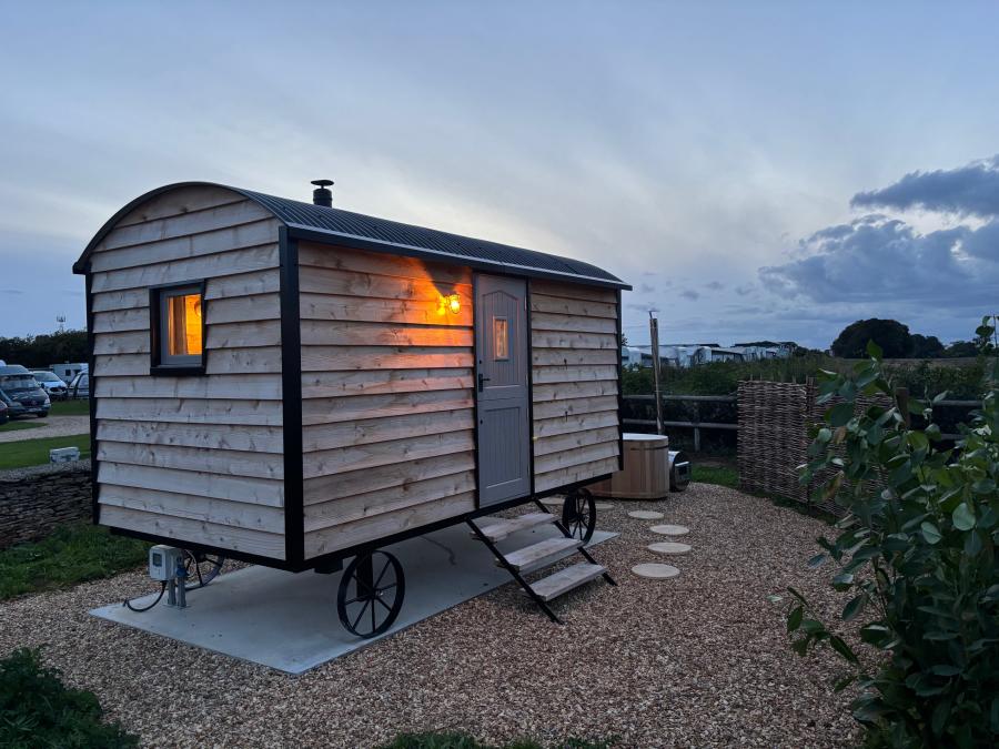 Shepherd Hut at dusk with hot tub