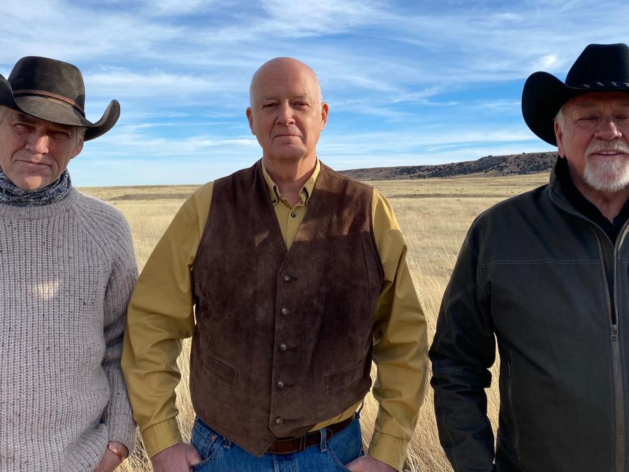 The three band members of 3 Trails West wearing traditional western clothing and cowboy hats with guitars and a stand up bass