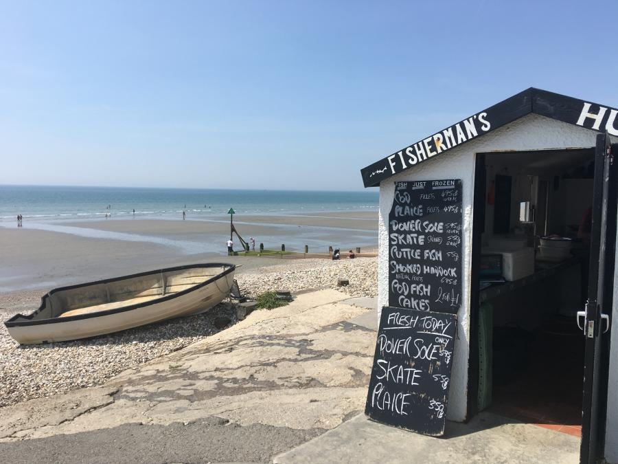 a view of east wittering beach with seafood hut