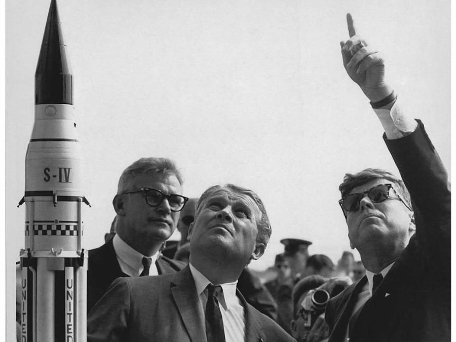Dr. Wernher von Braun explains the Saturn Launch System to President John F. Kennedy. NASA Deputy Administrator Robert Seamans is to the left of von Braun.