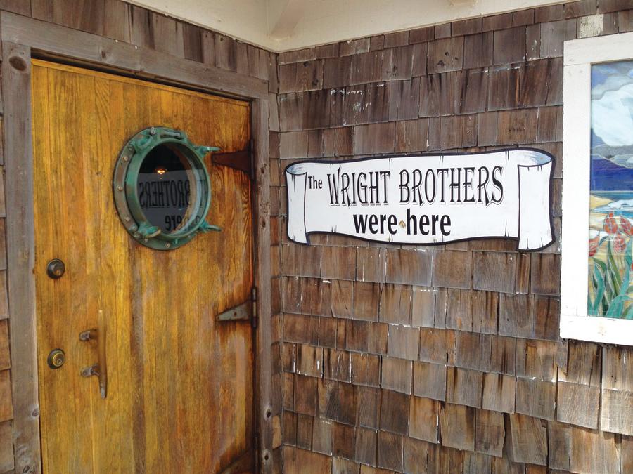 wright brother we were here sign black pelican