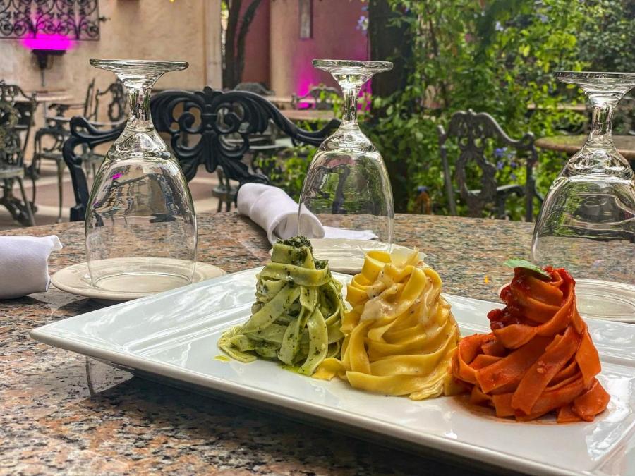 Green, Yellow and Red Pappardelle on a white plate