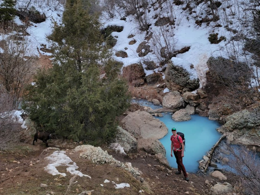 teenage boy stands near hot pots