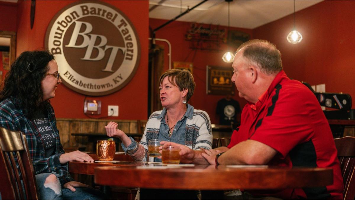 a group of people enjoying drinks at bourbon barrel tavern