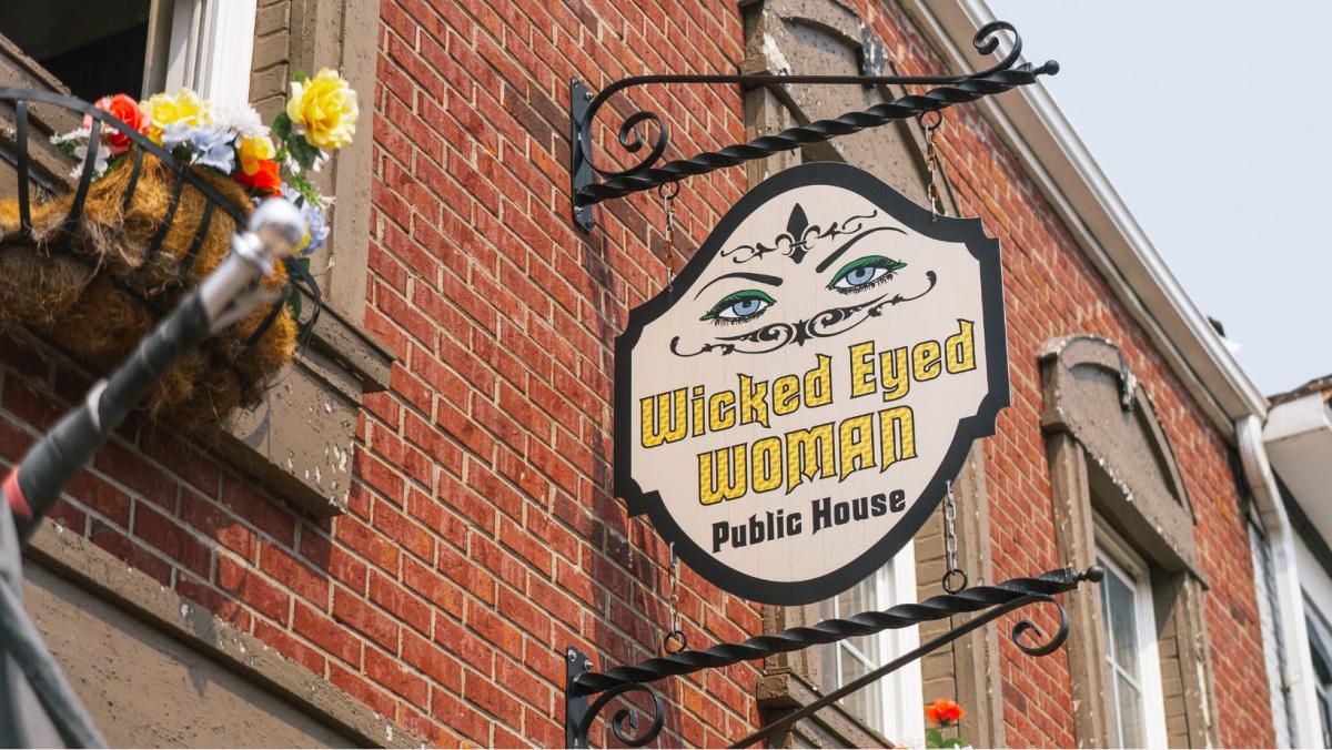 wicked eyed woman signage outside building