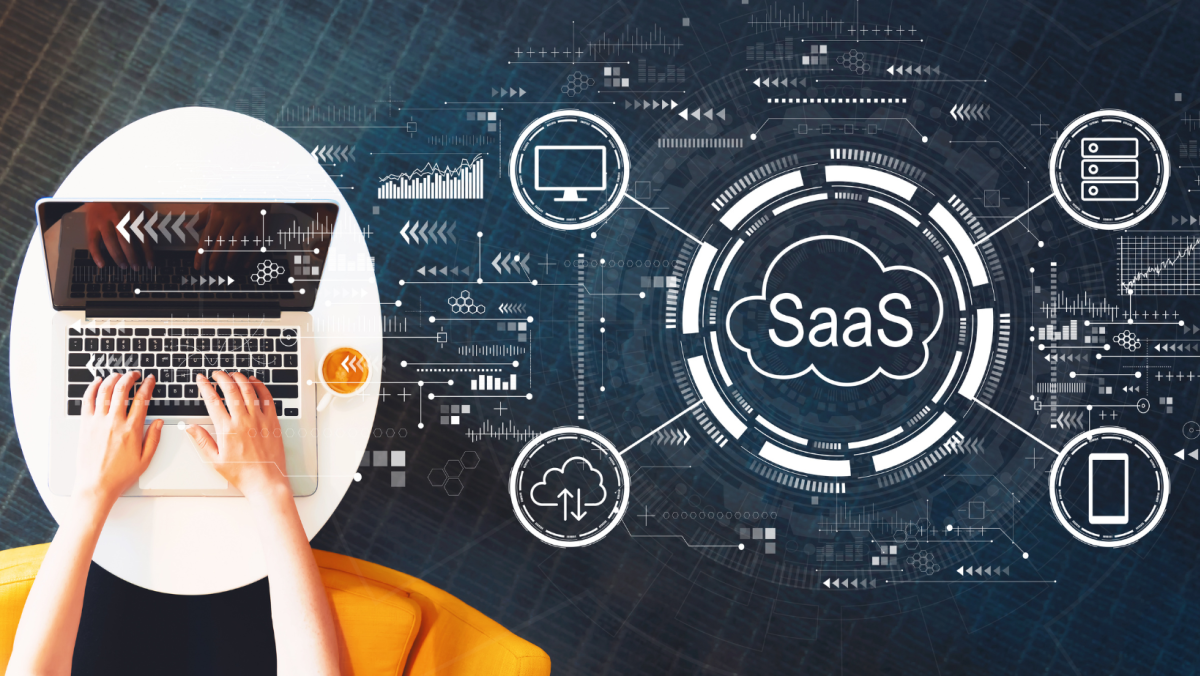 SaaS Graphic with laptop on table and person's hands