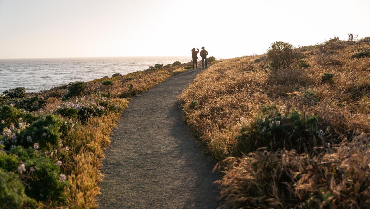 Couple walking trail on Fiscalini Ranch Preserve in Cambria