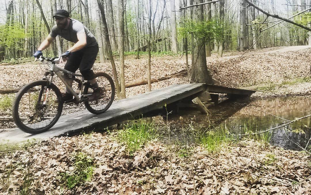 Man going over a bridge on a bike