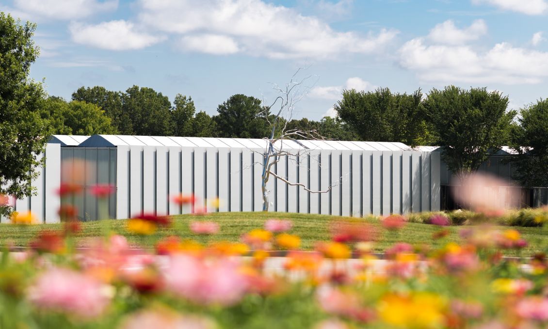 The NCMA Art Museum With Flowers In The Foreground In Raleigh, NC