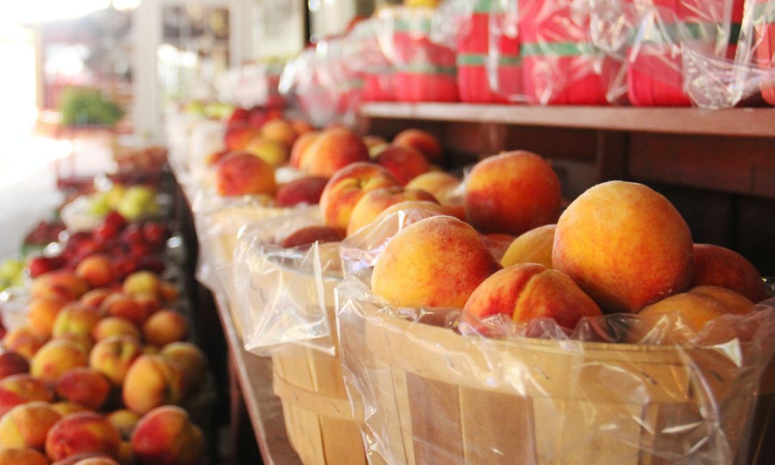 Bushels of peaches for sale at farmers market
