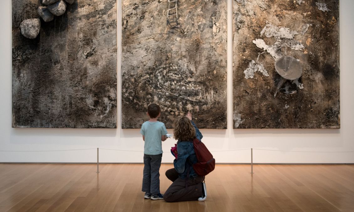 Child and mother looking at art