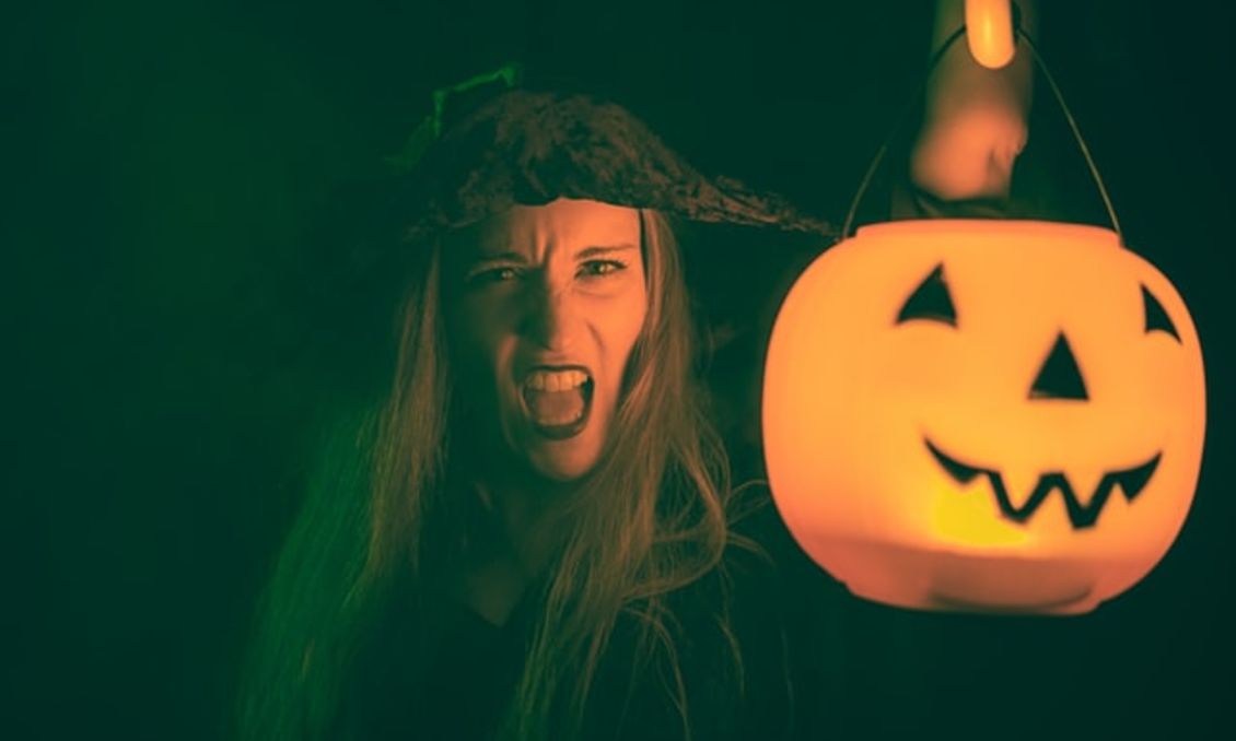 Spooky witch with jack-o-lantern