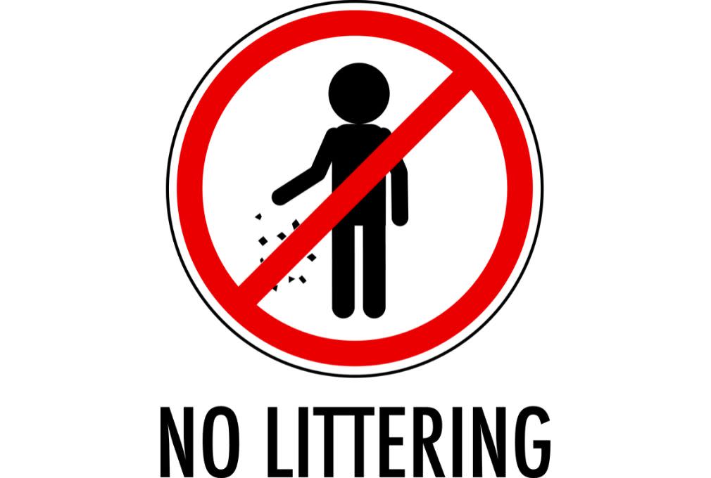 Red and black "No Littering" sign with a figure dropping litter. A red circle with a diagonal line overlays the figure, indicating prohibition.