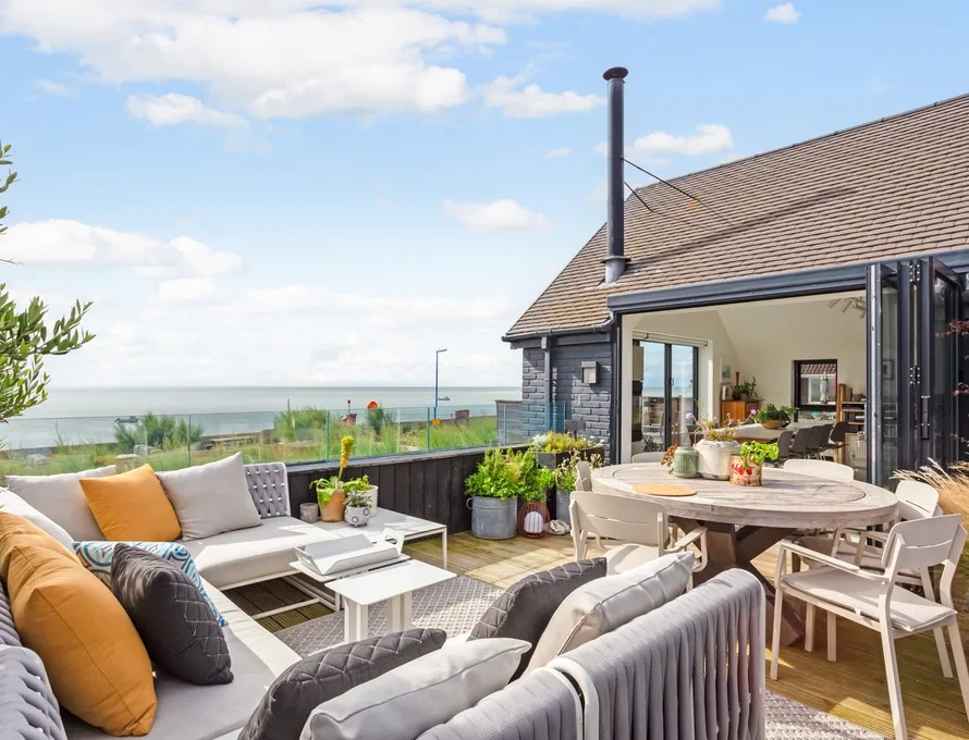 A view out to sea from the seating area of a house
