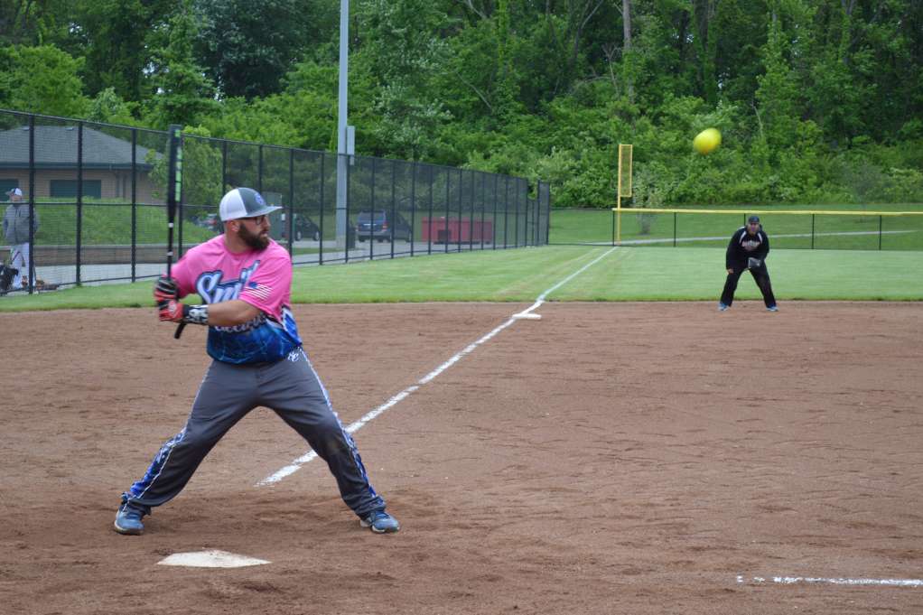 ϾA batter takes a swing in a softball tourney}}