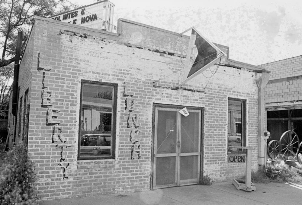 Photo of exterior view of the Liberty Lunch nightclub It is a small brick building with faded paint