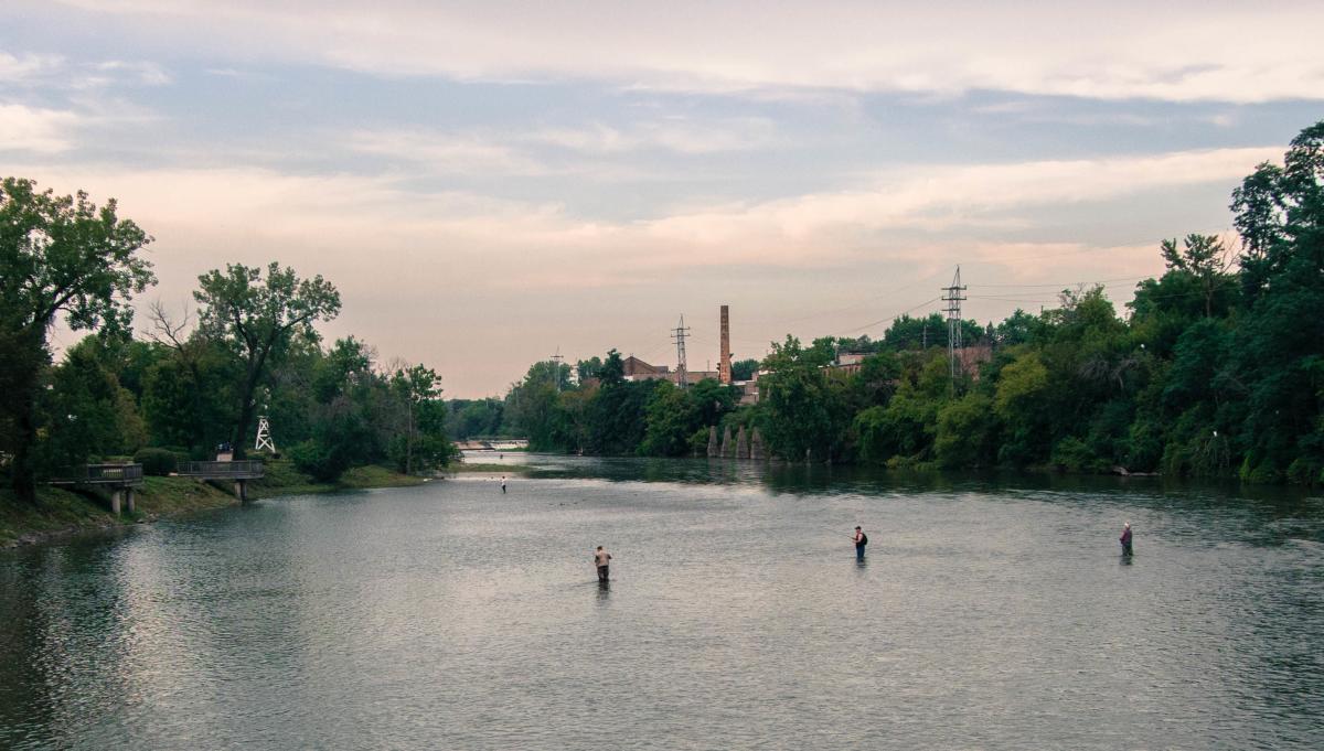 Anglers wade the Fox River in Batavia at dusk