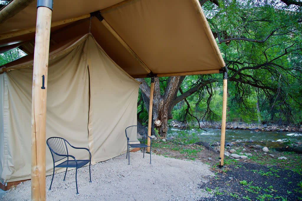 A glamping tent along the banks of the Poudre River