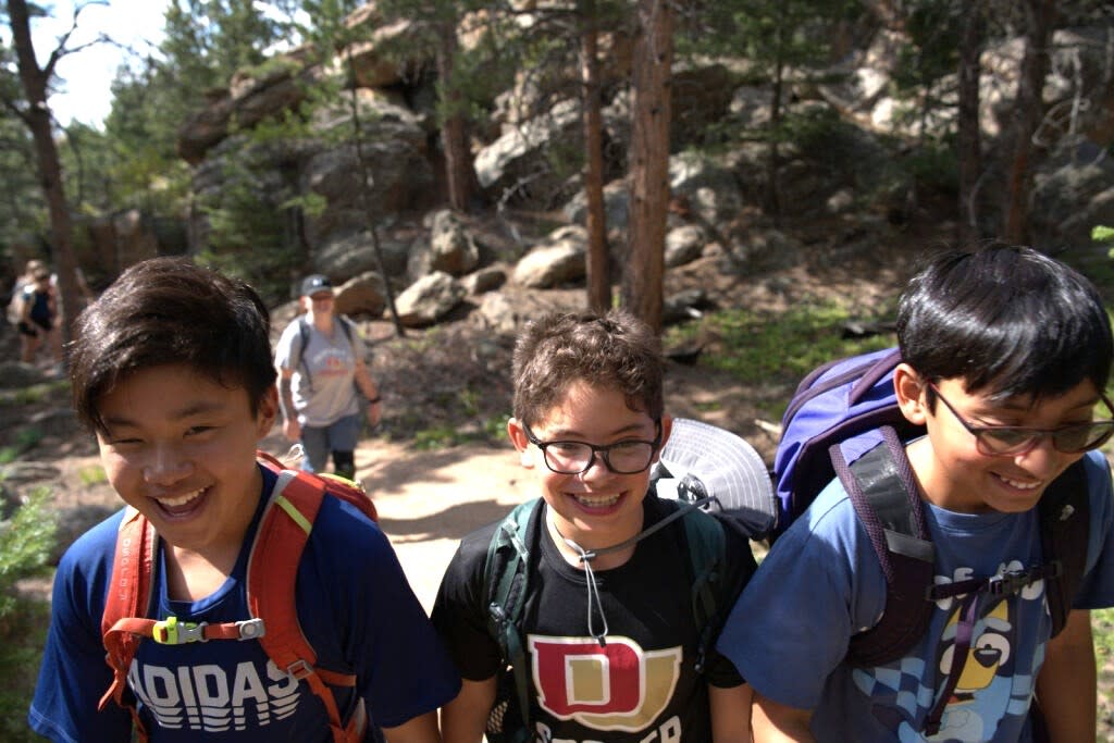 Three youth campers enjoying the outdoors at Kennedy Mountain Campus.