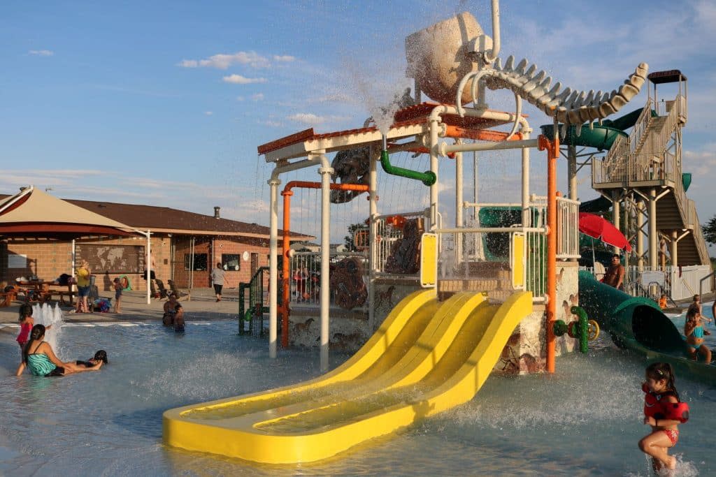 Photo of yellow water slides designed with a dinosaur bone theme at the Discovery Bay Water Park in Greeley, Colorado