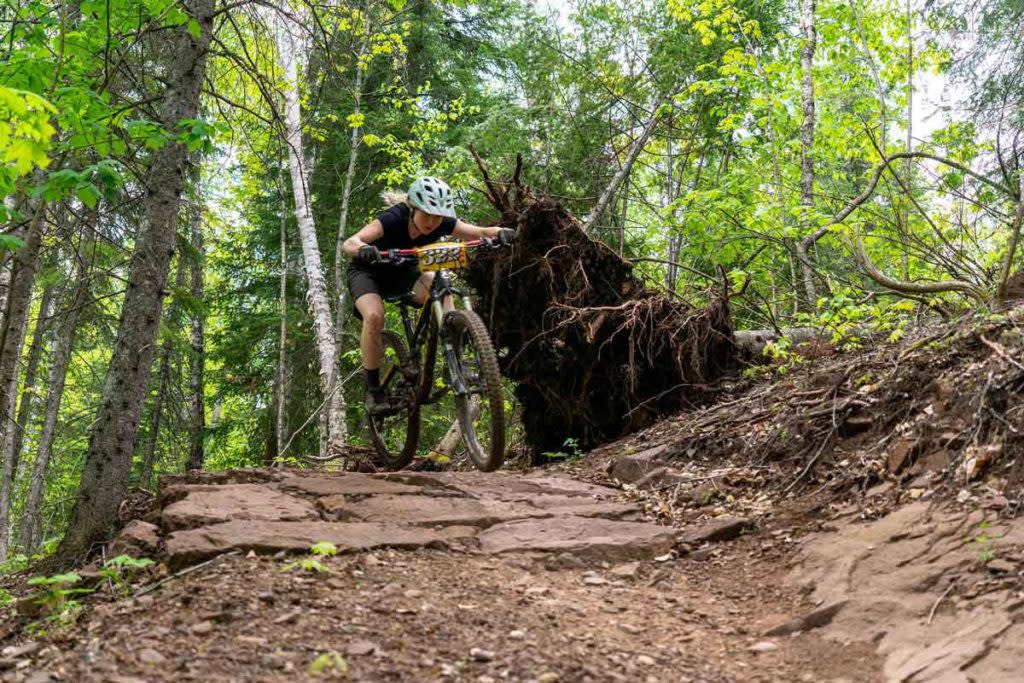 Woman rides singletrack trail in copper harbor