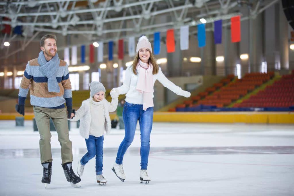 Family skating in hockey arena