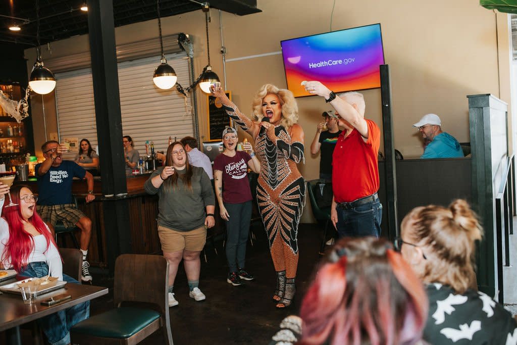 Drag Queen cheersing the crowd at local bar