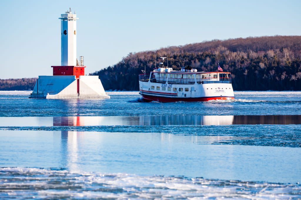 A Mackinac Island Ferry Company boat makes its way through the ice to Mackinac Island on a sunny winter day