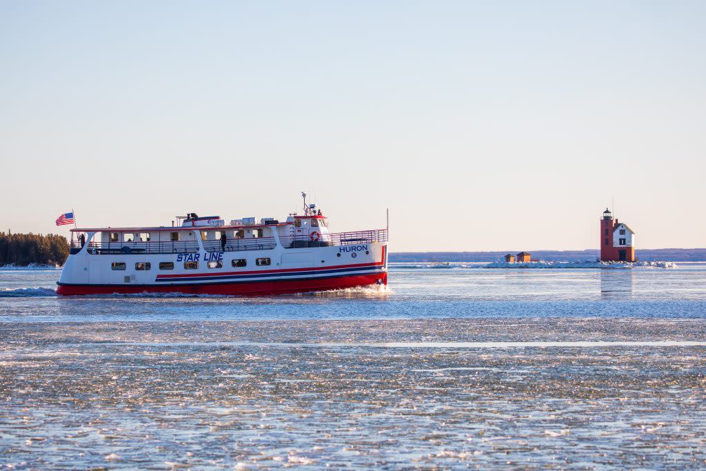 ’s mighty Huron ferry boat plies through the ice off Mackinac Island near Round Island Lighthouse