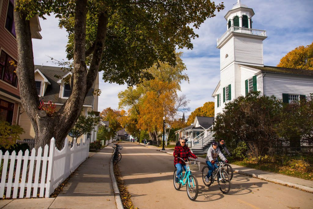 Fall dresses up Mackinac Island with colorful leaves that create a backdrop for scenic bike rides through town.