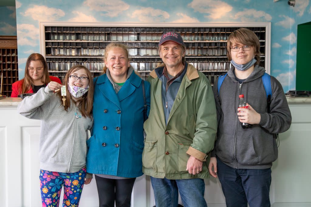 A family checks in at Mackinac Island’s Grand Hotel as the first guests of the 2022 season.