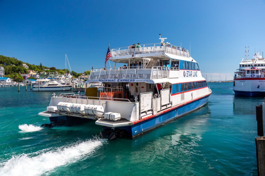 A Mackinac Island ferry boat leaves the dock to bring passengers back to the mainland