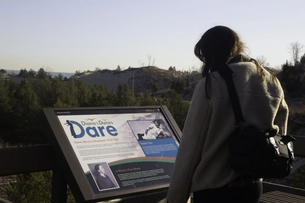 Girl looking at the Diana Dunes Dare sign
