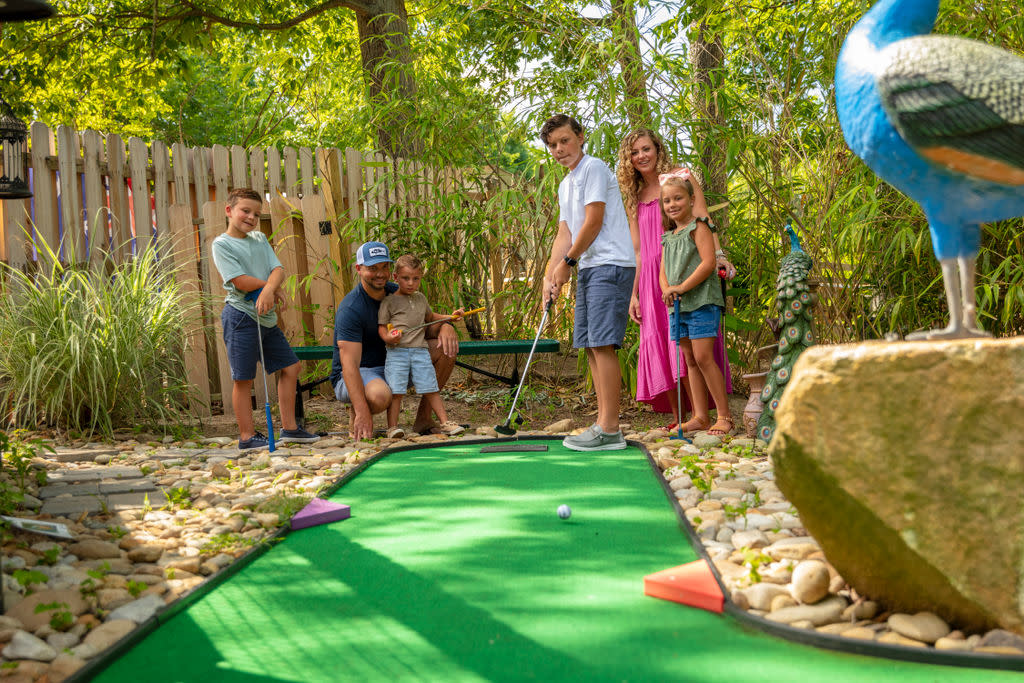 Family playing putt putt at Tiger World