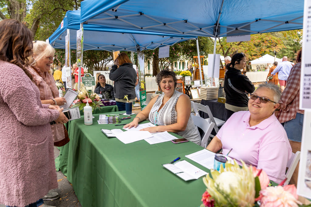 Group working and group visiting information tent at an event