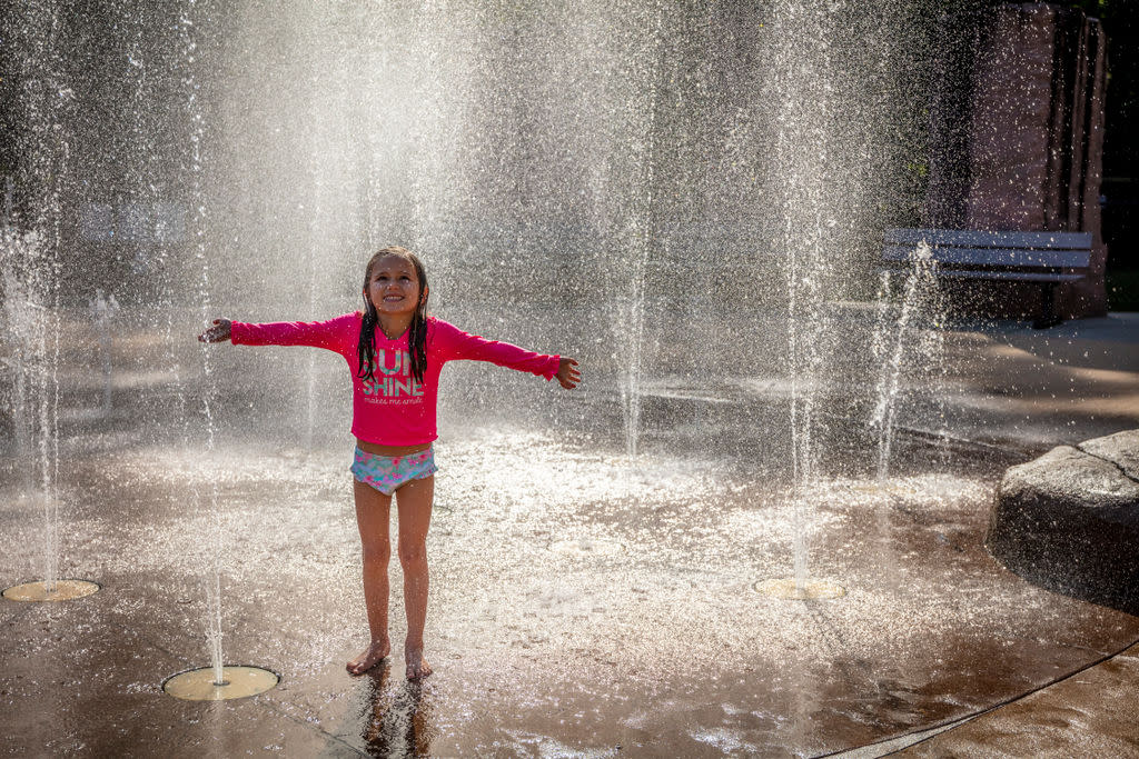 Little girl playing on splash pad