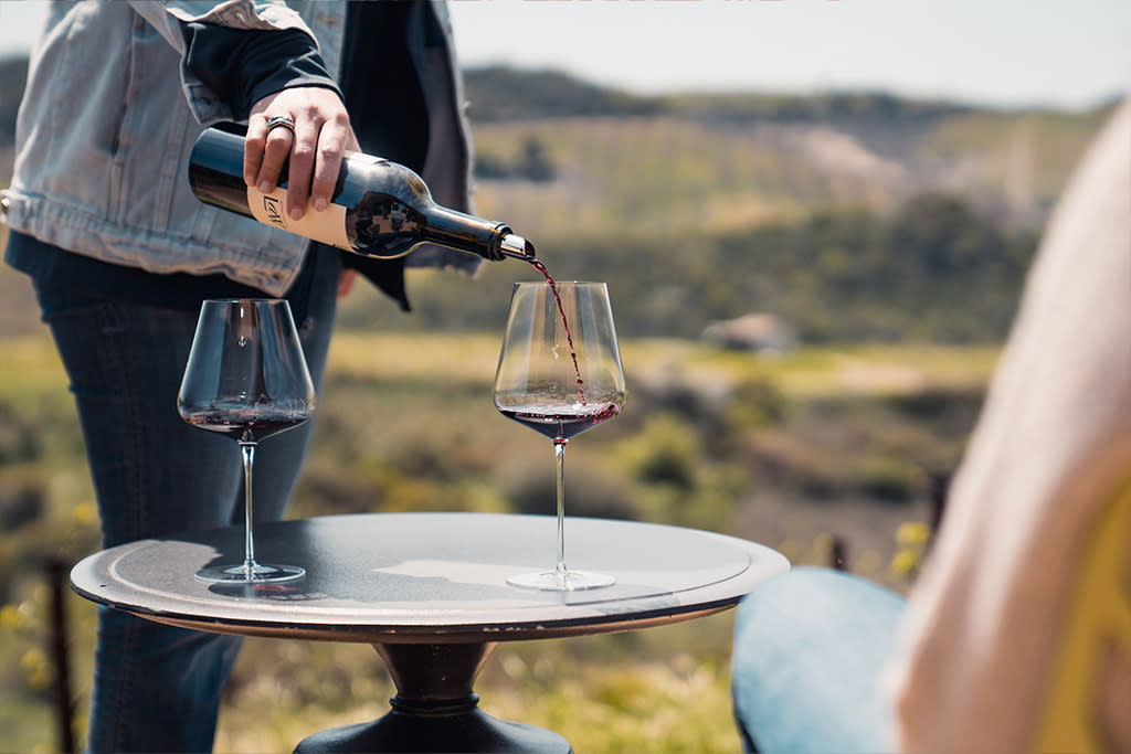 Two glasses of wine being poured