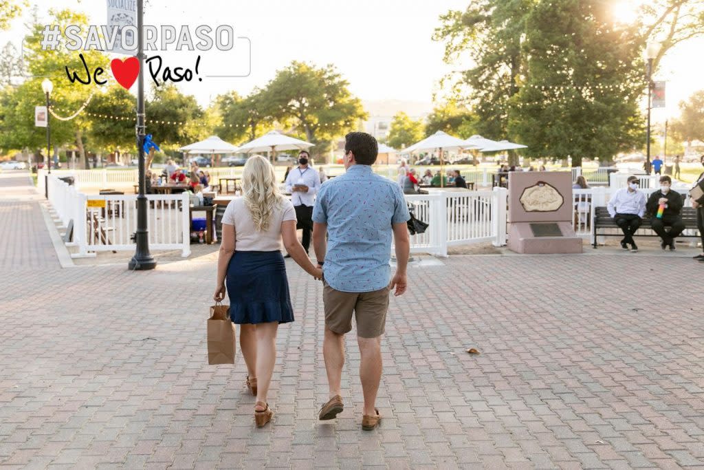 People walking toward park tables