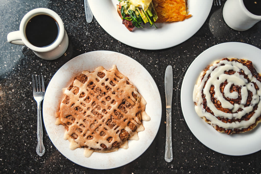 Photo of a snickerdoodle pancake and cinnamon roll pancake with coffee on a table
