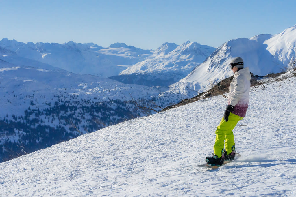 A person snowboarding in a mountain pass