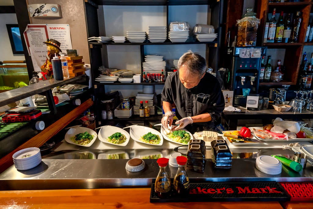 a sushi chef preparing dinner at a restaurant