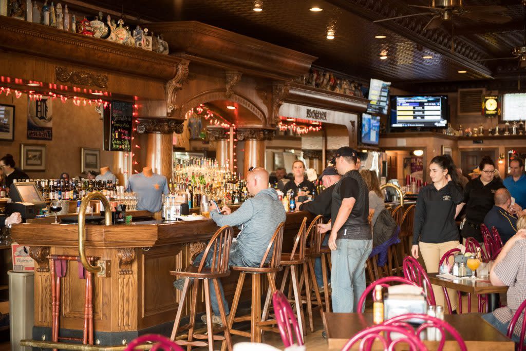 A downtown Mackinac Island bar bustles with guests eating and drinking