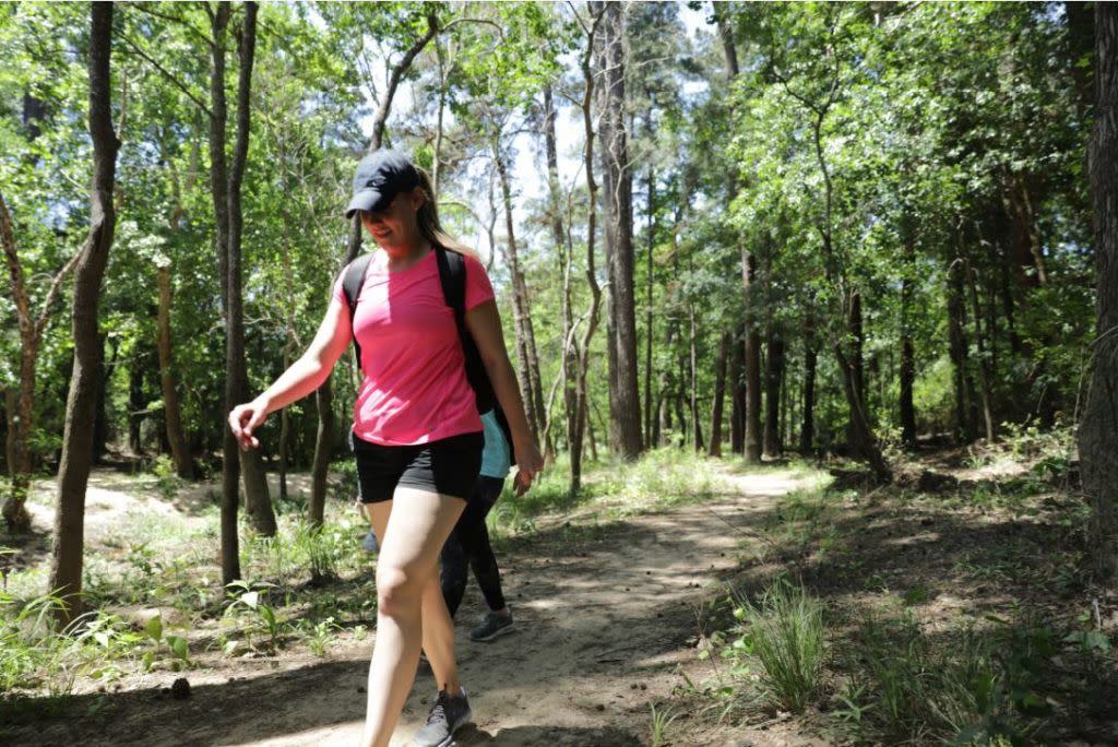 People walking on a trail in The George Mitchell Nature Preserve