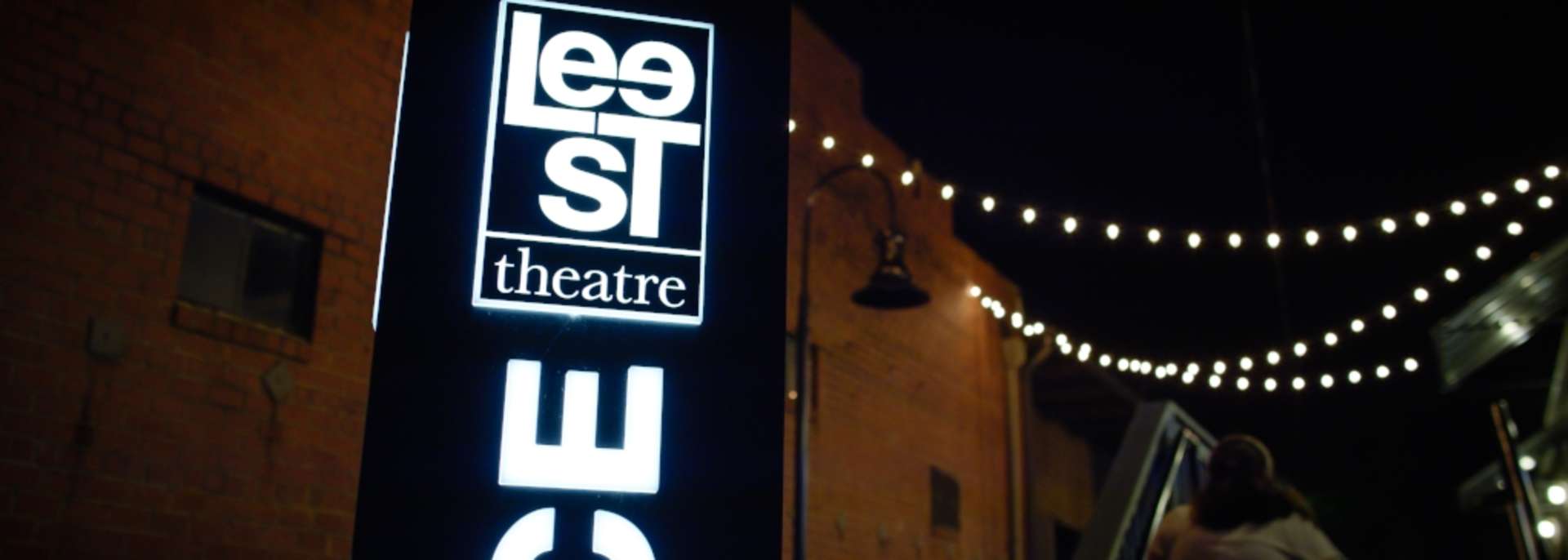 Lee St. Theater Sign lit up at night