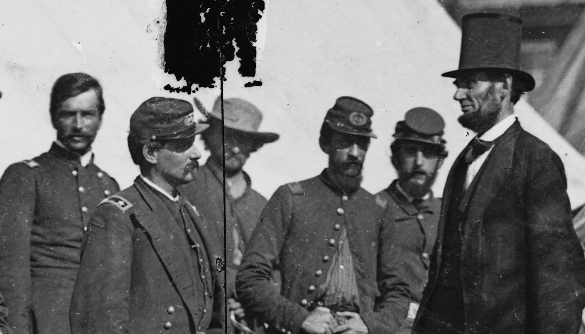 Abraham Lincoln standing with a group of soldiers at the Battle of Antietam