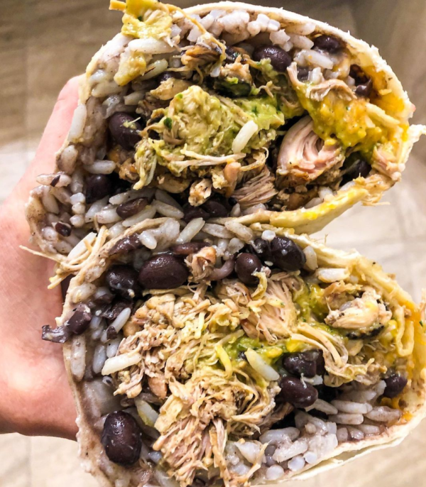 A chicken burrito split in half at Cali Burrito.