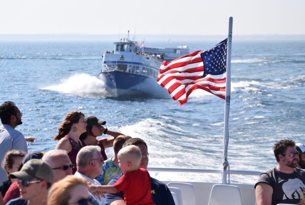 An American flag waves in the breeze on the back of the Mackinac Island ferry boat making its way to the island