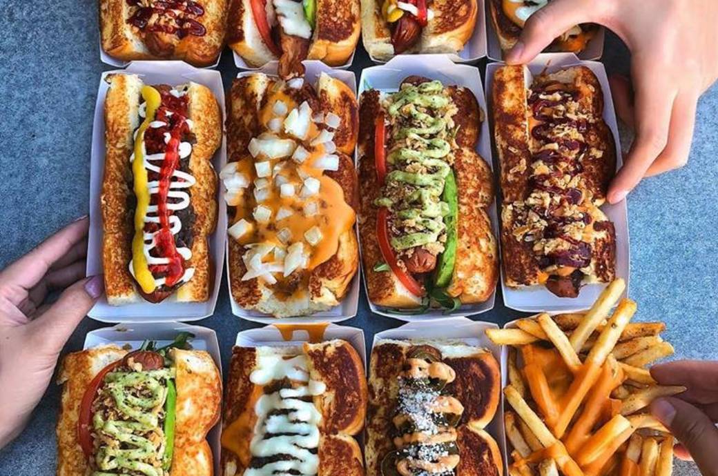 Dog Haus Biergarten in Chandler, AZ - overhead view of sausages and all-beef hot dogs
