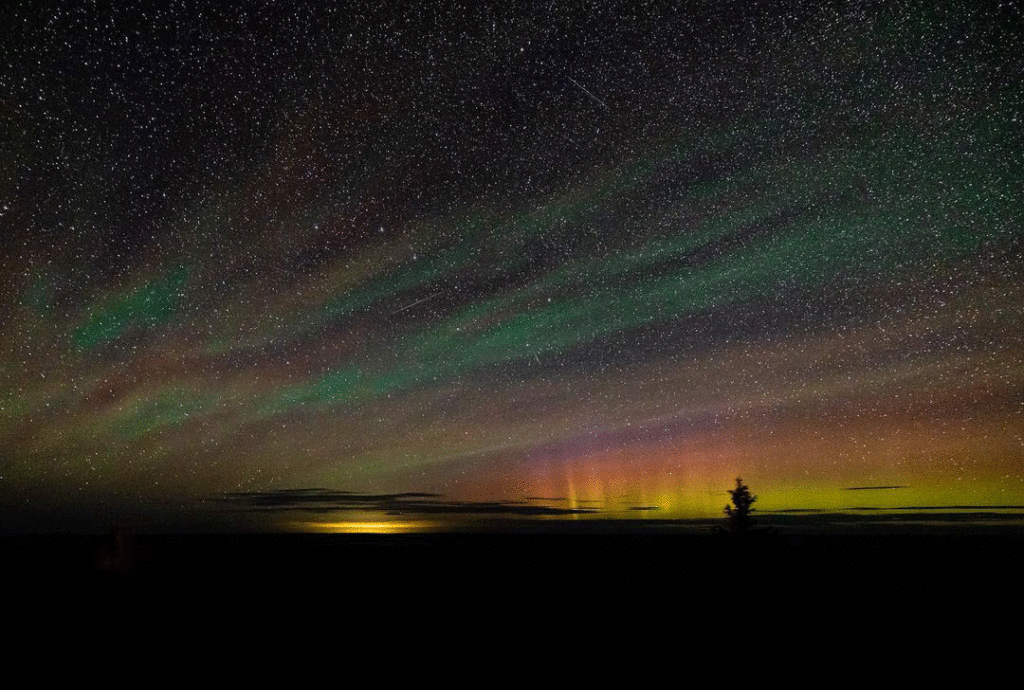 A touch of Aurora Borealis Colors and countless stars dot the night sky